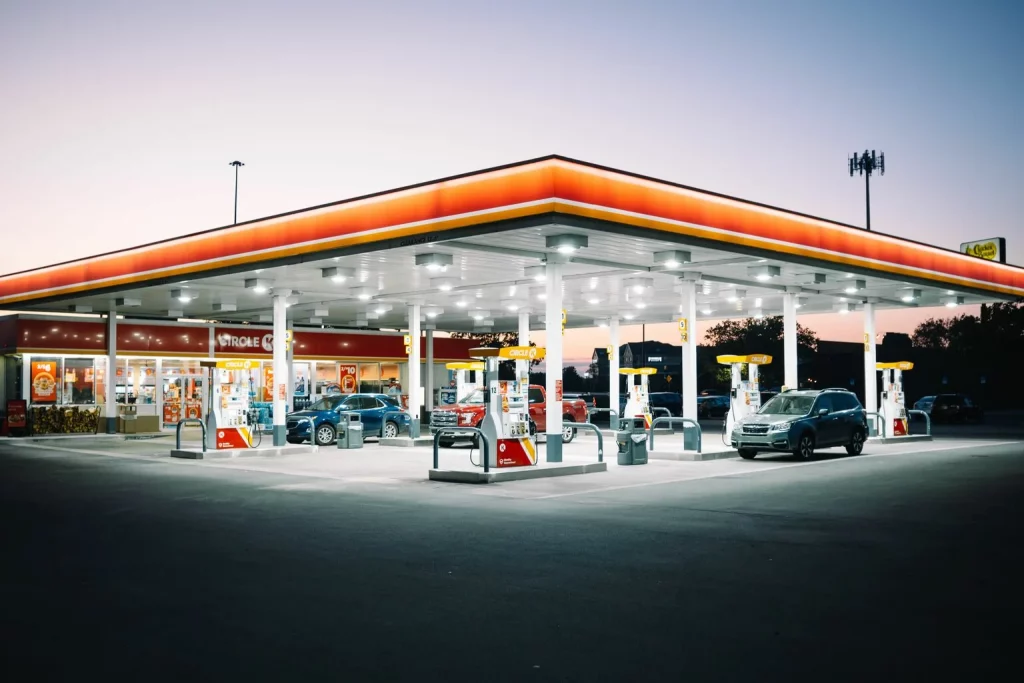 Gas station at dusk with cars refueling
