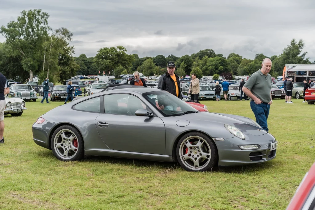 ACV Auctions: Stock Price Unlikely To Move Up In The Near Term (NYSE:ACVA) People Are Looking At A Gray Porsche 911 At A Car Auction