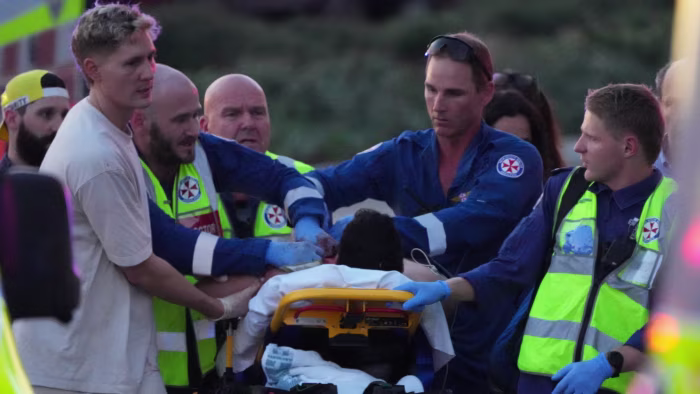 Twelve killed in gun attack at Jewish event at Sydney’s Bondi Beach Emergency workers and paramedics transport a person on a stretcher, attending to injuries after a reported shooting.