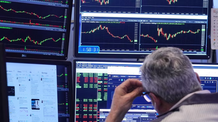 US stock futures slip after Oracle results disappoint A trader looks at multiple computer monitors displaying stock charts and market data on the floor of the New York Stock Exchange.