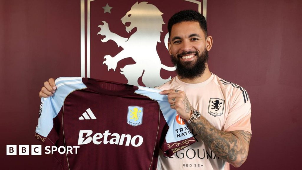 Aston Villa: Douglas Luiz rejoins after Youri Tielemans sidelined for 8-10 weeks Douglas Luiz smiles as he holds up the Aston Villa shirt at his signing