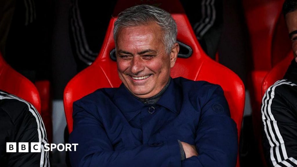 Jose Mourinho smiles and folds his arms