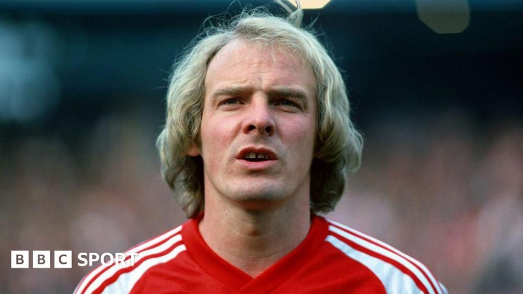 Terry Yorath wearing a red Wales matchday shirt