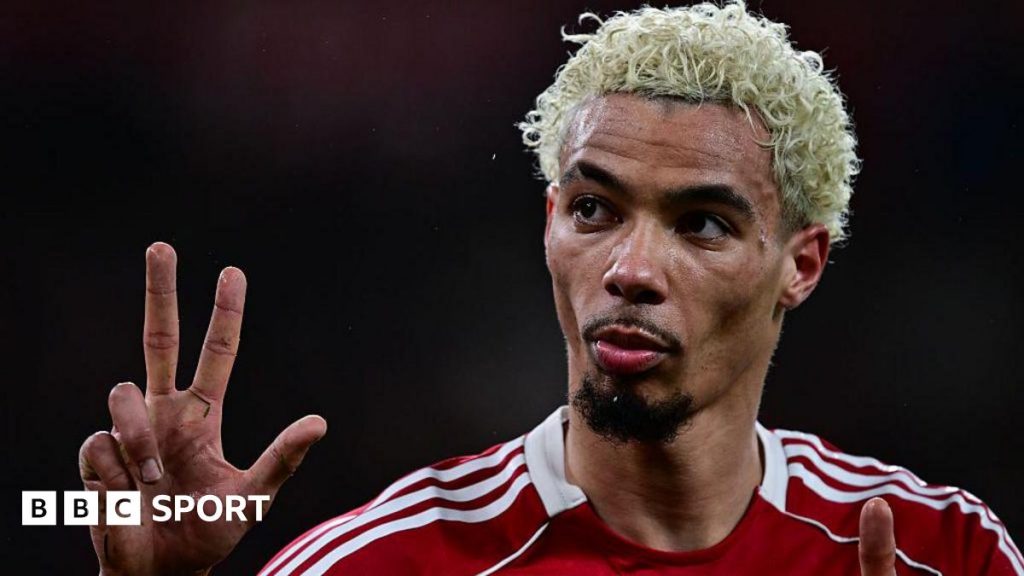 Hugo Ekitike gestures the score to Newcastle fans at Anfield