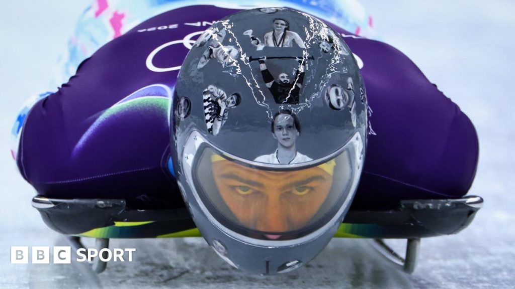 Vladyslav Heraskevych wears helmet with images of those killed in Ukraine war while training for skeleton in Cortina, Italy at Winter Olympics